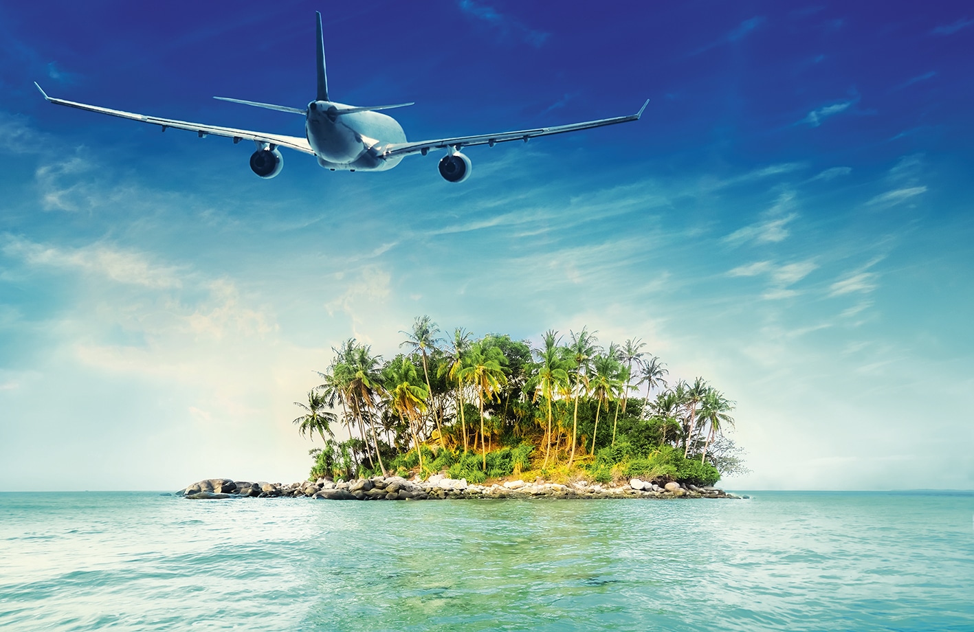 Airplane flying over amazing ocean landscape with tropical island. Thailand travel destinations